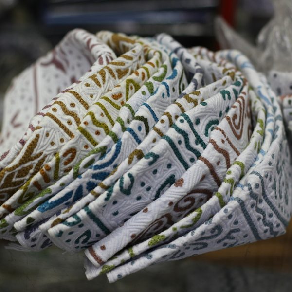 White Omani kummas embroidered with coloured thread